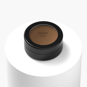 Sparkle Eyeshadow, a burnt sugar shade, vegan and cruelty-free with ethically sourced ingredients. In a black container on white background.