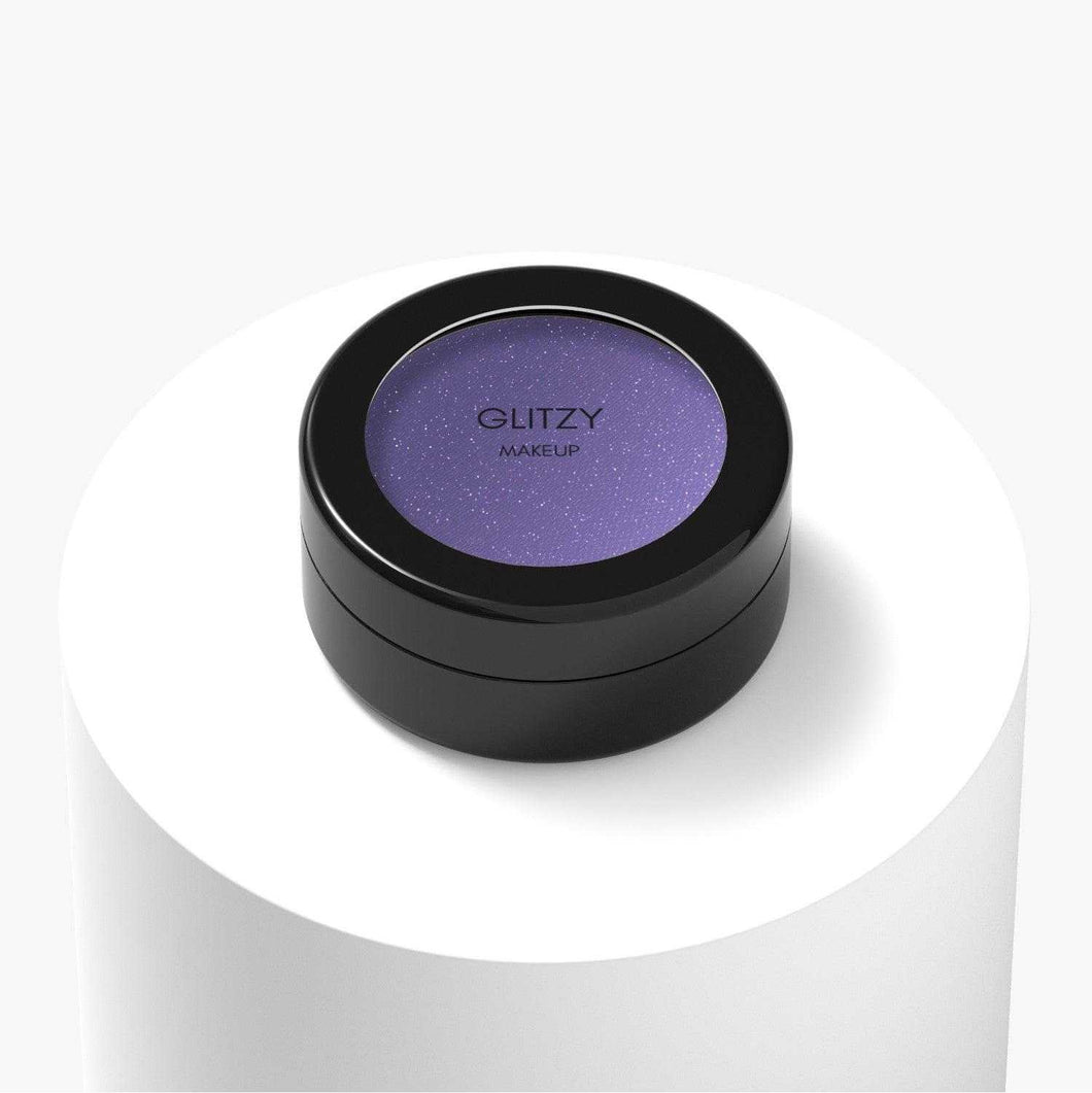 Sparkle Eyeshadow, a vibrant purple shade, vegan and cruelty-free with ethically sourced ingredients. In a black container on white background.